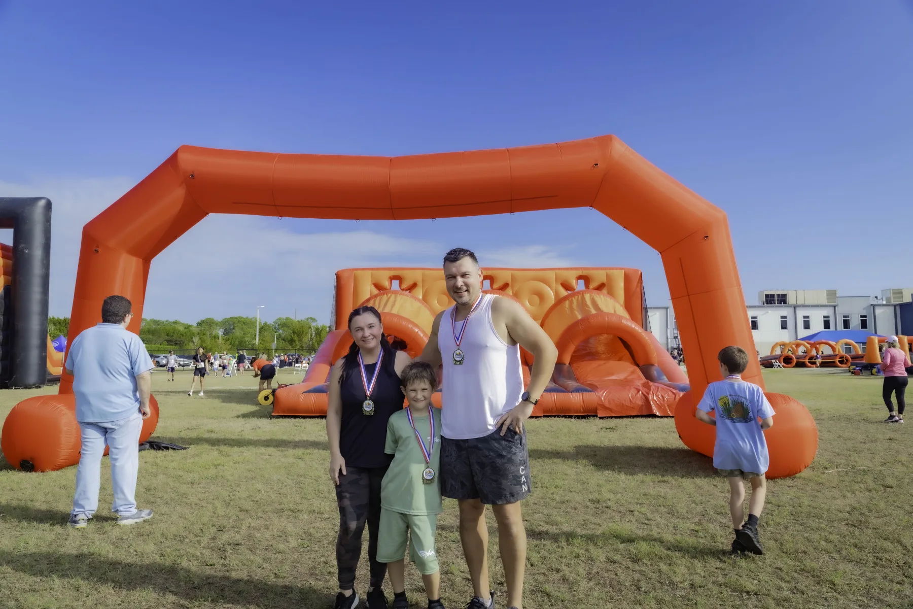 Participants wearing their Great Inflatable 5K finisher medals